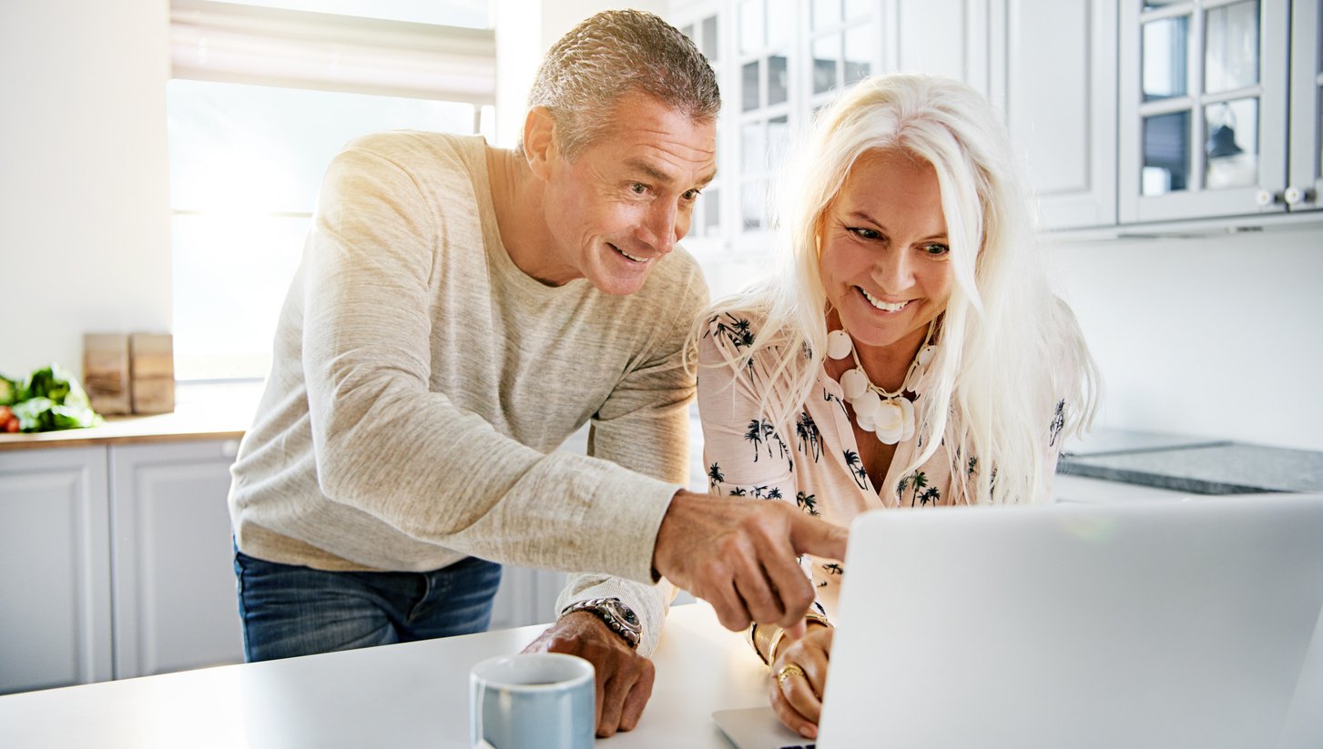 Happy Couple Looking at Computer